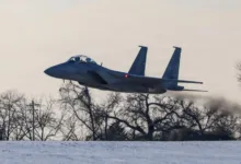 F-15EX fighter jet takes off, leaving a trail of smoke.