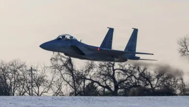 F-15EX fighter jet takes off, leaving a trail of smoke.