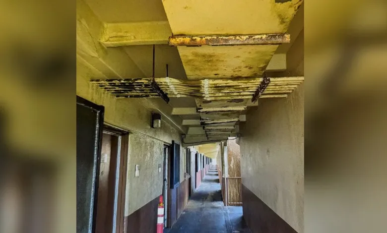 Moldy ceiling in a damaged barracks hallway in Guam. Renovation needed.