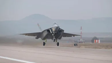 Turkish Aerospace KAAN fighter jet taking off on runway. Gray military aircraft in flight.