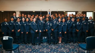Large group of Air Force officers in dress uniforms posing indoors.