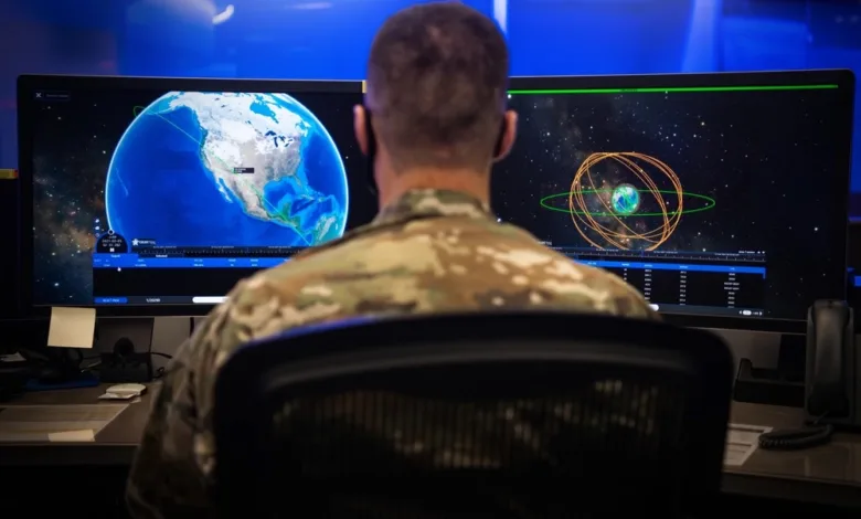 Air Force operator monitoring Earth and satellite data on large screens.