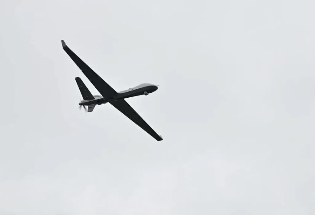 Belgian SkyGuardian RPAS in flight against a cloudy sky.