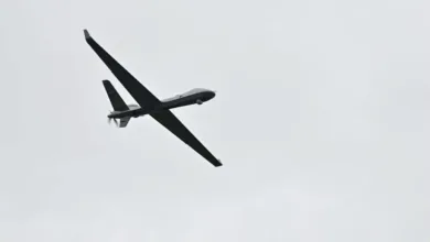 Belgian SkyGuardian RPAS in flight against a cloudy sky.