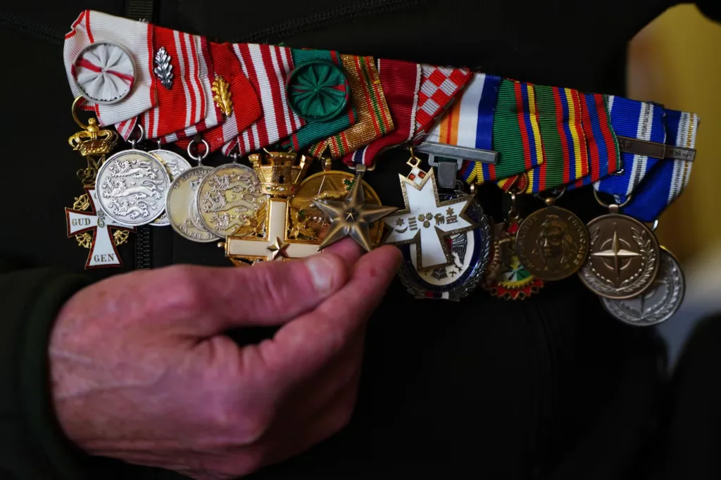 Current image: Danish veteran's medals, including Danish war medals, being held up for display.
