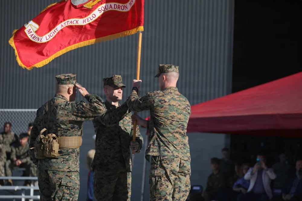 Marines passing HMLA-169 guidon during a change of command ceremony.