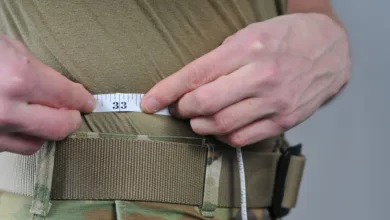 Measuring waist size with tape measure showing 33 inches.