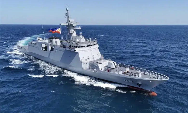 Philippine Navy frigate BRP Jose Rizal sailing on the ocean with the Philippine flag waving.