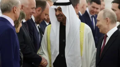 Sheikh Mohammed bin Zayed Al Nahyan shaking hands with Vladimir Putin.