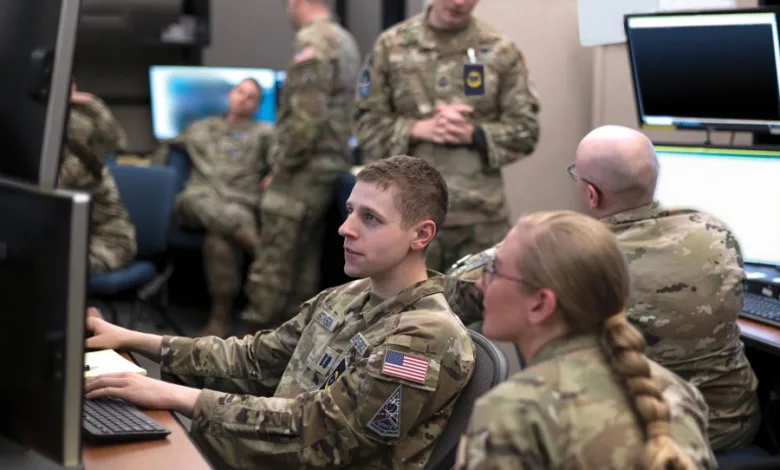 Space Force personnel working at computer stations in a control room setting.