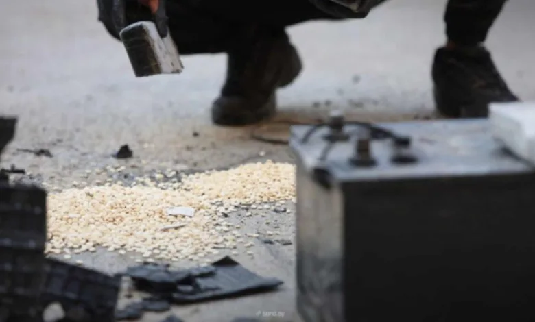 Man dismantling drug smuggling equipment, Syria airstrikes aftermath.