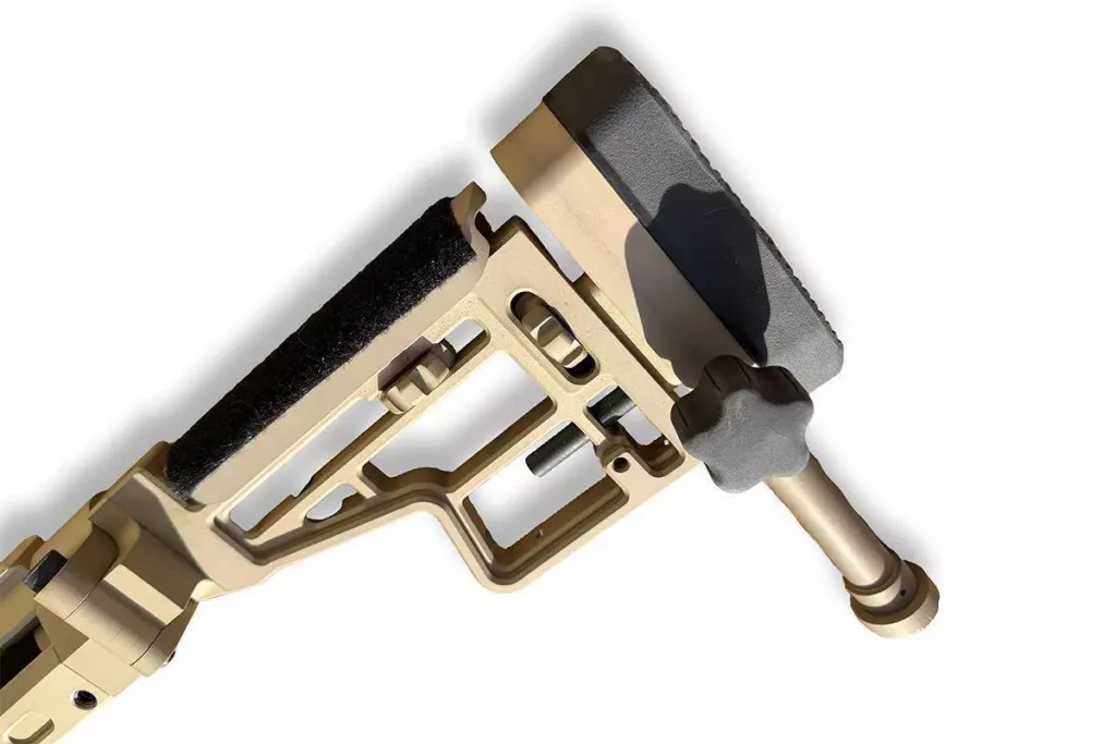 Adjustable stock on a tan .50 BMG rifle, close-up. Part of the Auto-Ordnance Thompson TAO50 rifle.