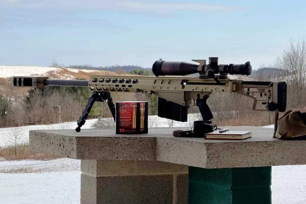 Auto-Ordnance Thompson TAO50 .50 BMG rifle on a shooting range with ammo and accessories.