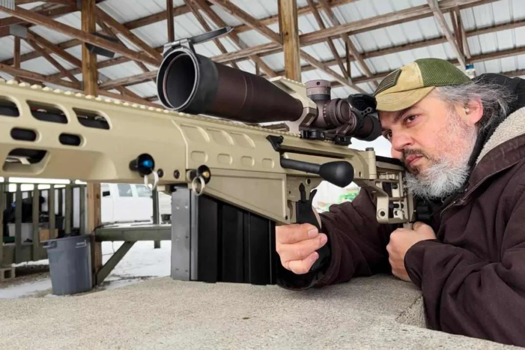 Man shooting Auto-Ordnance Thompson TAO50 .50 BMG rifle at range.