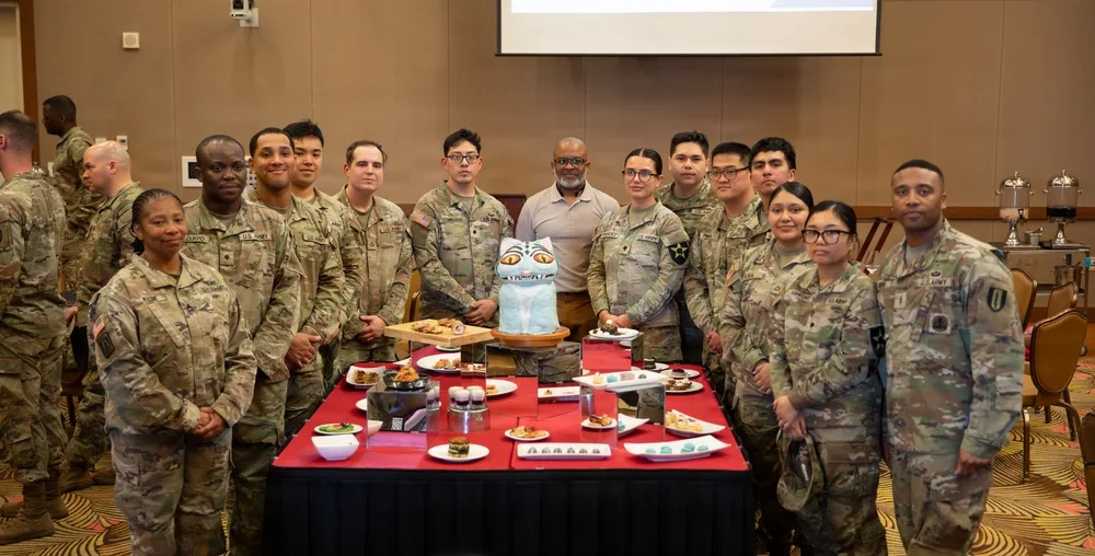 Eighth Army culinary team with rations display and cake.
