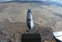 Hypersonic missile over desert landscape viewed from aircraft.
