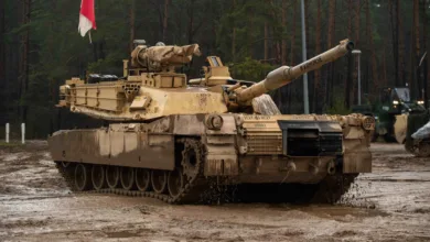 M1 Abrams tank "WARHORSE" in muddy field during winter training in Poland.