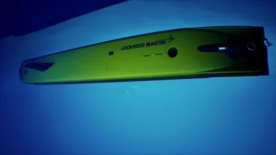 Lockheed Martin autonomous underwater vehicle (AUV) in water. Yellow submarine with black accents.