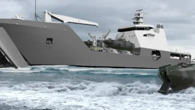 Military landing craft deploying vehicles onto a beach, with a Humvee exiting the larger vessel.