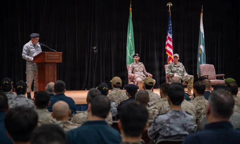 Pakistan Navy assumes command of Combined Task Force 150 during ceremony with flags displayed.