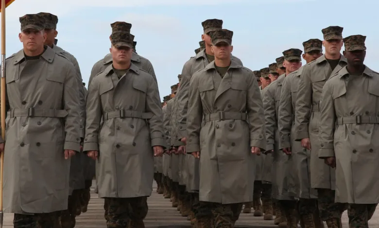 US Marines in formation wearing trench coats and campaign hats.