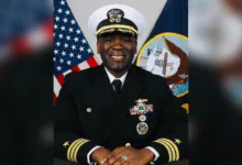 Portrait of a smiling U.S. Navy officer in uniform with medals.