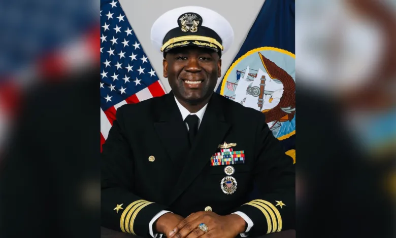 Portrait of a smiling U.S. Navy officer in uniform with medals.