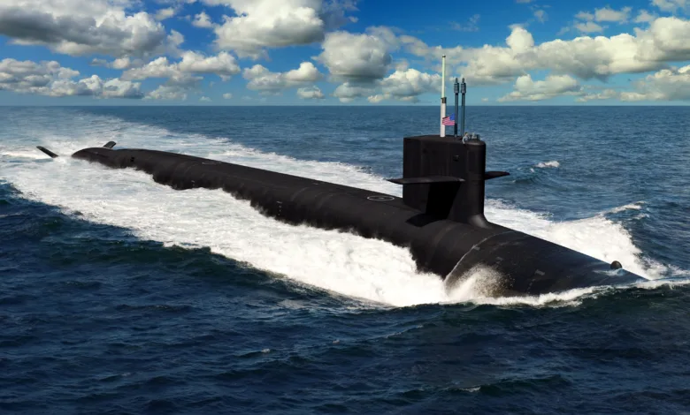 US Navy submarine surfacing in ocean, American flag visible on mast.