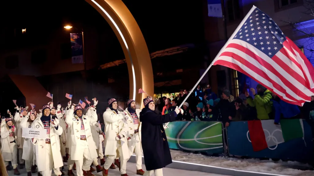 US team marching with flag at opening ceremony.