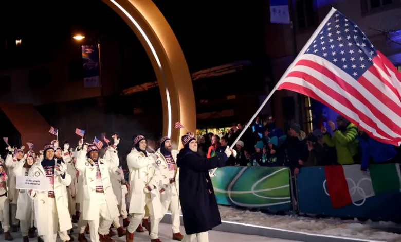 US team marching with flag at opening ceremony.