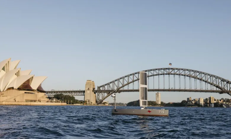 Autonomous boat sailing in Sydney Harbour with Opera House and Harbour Bridge.