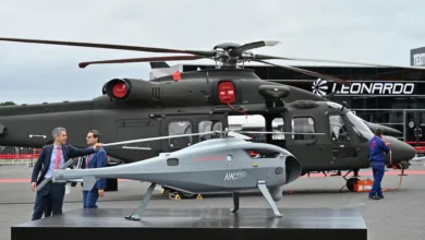 AW Hero drone in front of Leonardo helicopter at an airshow.