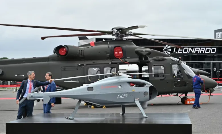 AW Hero drone in front of Leonardo helicopter at an airshow.