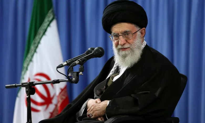 Ayatollah Ali Khamenei, Supreme Leader of Iran, seated with flag backdrop.
