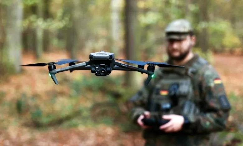 DJI Mavic 3 Enterprise drone in flight, soldier with controller in background.