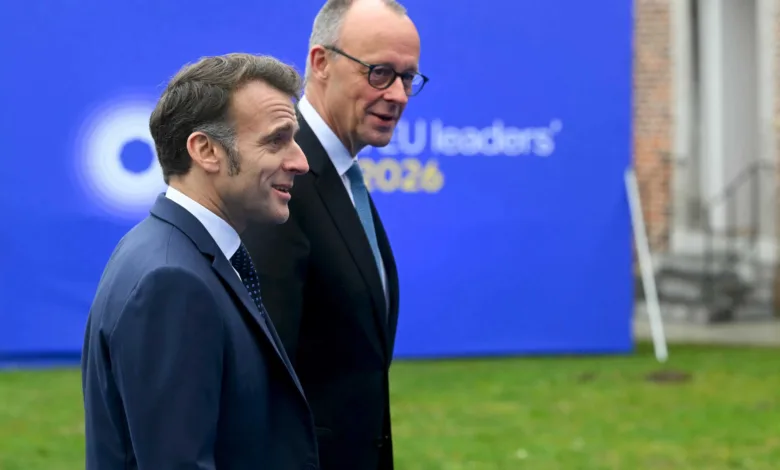 Emmanuel Macron and Alexander De Croo walking, EU Leaders 2026 in background.