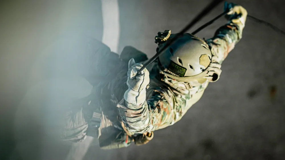 EOD technician rappelling during daytime training exercise.
