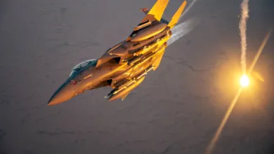 F-15 Eagle fighter jet deploying flares against a desert backdrop, golden hour lighting.