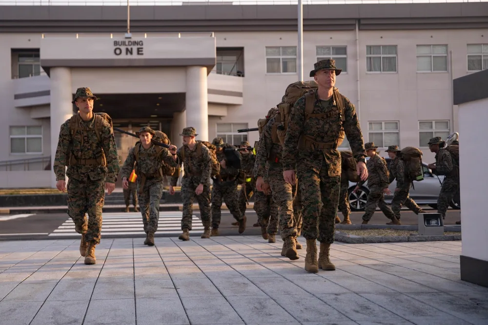 Marines hike with packs near Building One, MCAS Iwakuni HHS supply hike.
