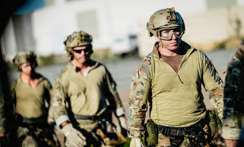 Military team in tactical gear, preparing for action in an outdoor setting.