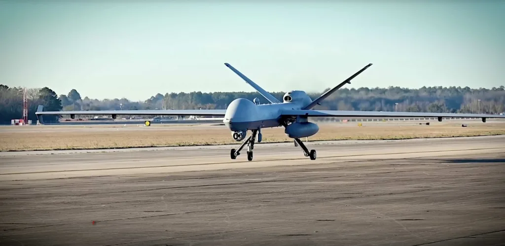 MQ-9 Reaper drone landing on a runway, showing its distinctive design.
