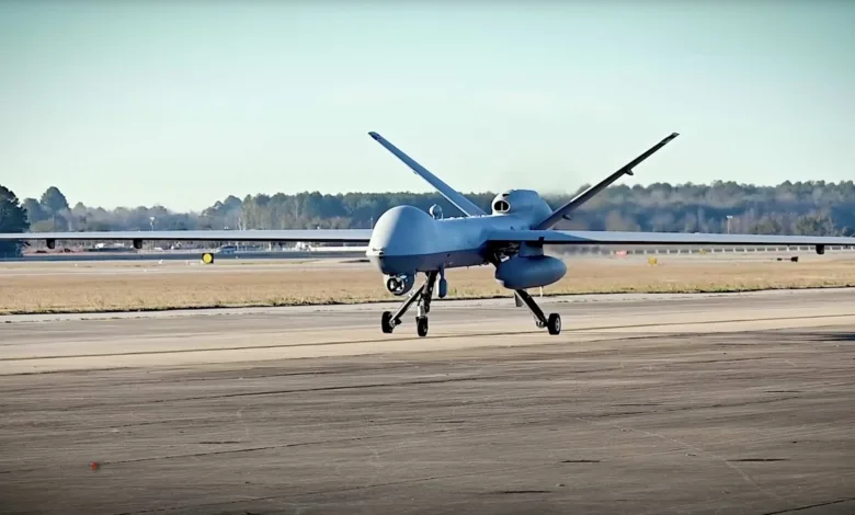 MQ-9 Reaper drone landing on a runway, showing its distinctive design.