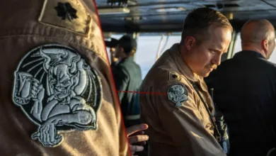 Navy officer with gargoyle patch on uniform sleeve.