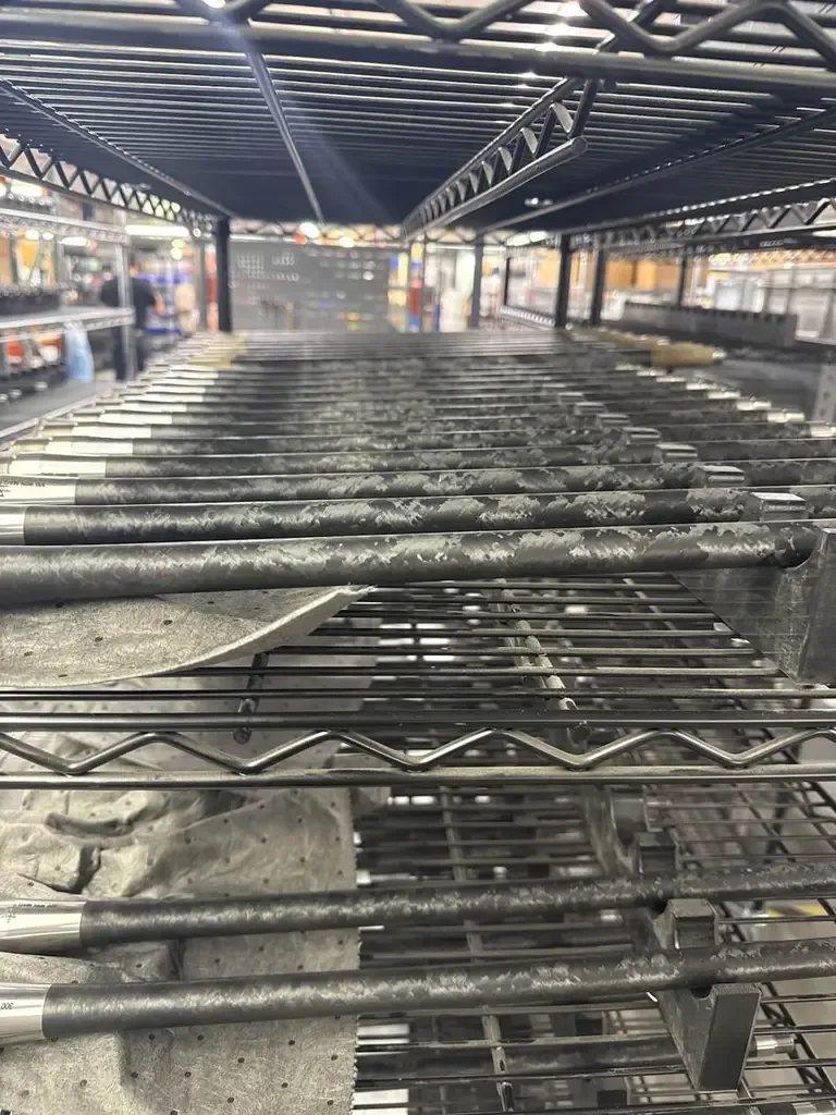 Seekins Precision barrels stored on metal shelving, close-up view.