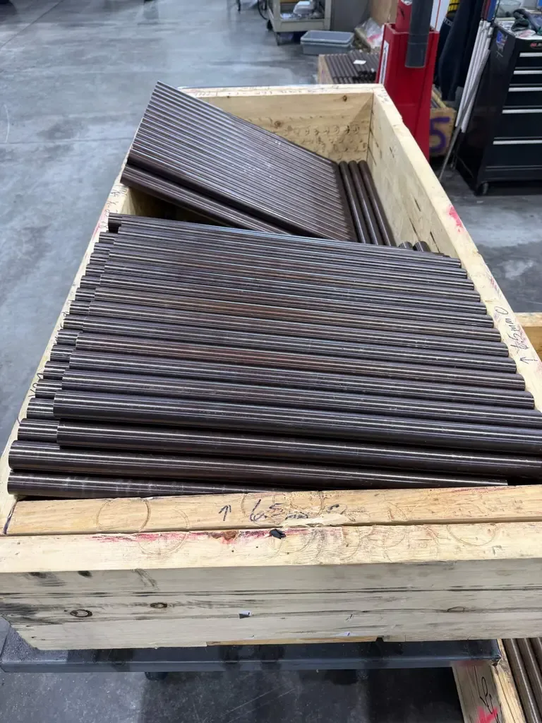 Seekins Precision barrels stacked in a wooden crate, close-up view.