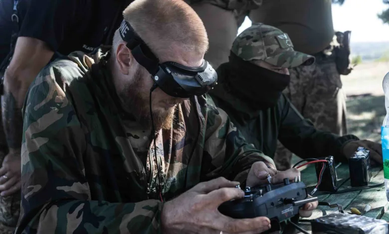 Soldier using drone controller with VR headset, camouflage uniform.