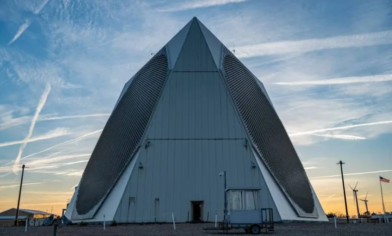 Stanley R. Mickelsen Safeguard Complex pyramid structure at sunset with contrails in the sky.