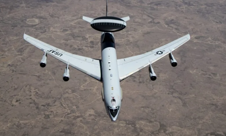 USAF E-3 AWACS airborne early warning aircraft with rotating radar dome.