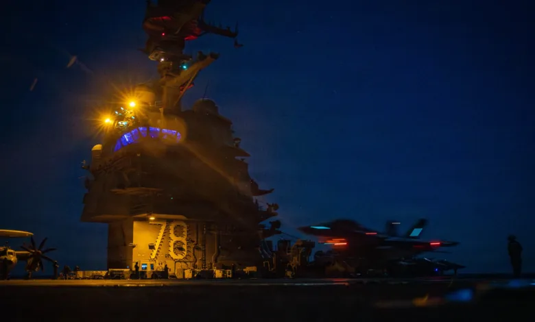 Night shot of USS Gerald R. Ford (CVN-78) with F-35C Lightning II aircraft on deck.