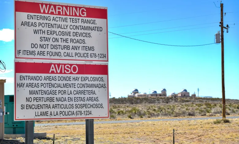 Warning sign: Active test range, explosive devices. Call police 678-1234.